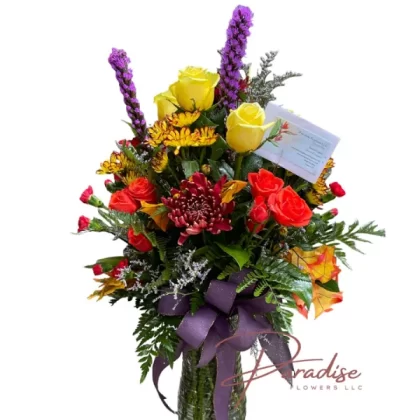 Autumn Whisper Florals featuring yellow roses, red chrysanthemums, orange mini carnations, orange spray roses, yellow daisies, liatris, limonium, and lush greenery.