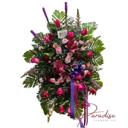 Beautiful Pink standing spray featuring pink roses, spray roses, snapdragons, red spray roses, liatris, mums, pink lilies, and lush greenery.