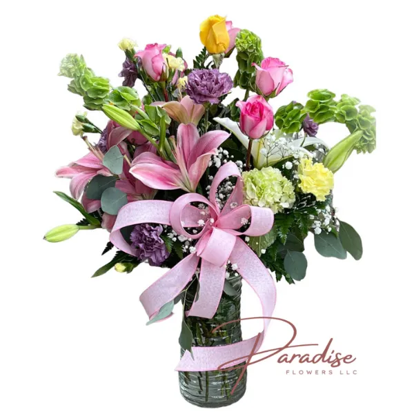 Beloved Mom Bouquet featuring lilies, roses, carnations, and bells in a stylish vase, symbolizing love and admiration.