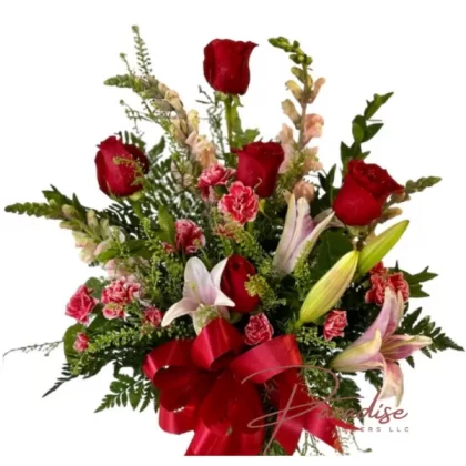 Birthday Wishes floral arrangement featuring red roses, pink lilies, snapdragons, mini carnations, and lush greenery.