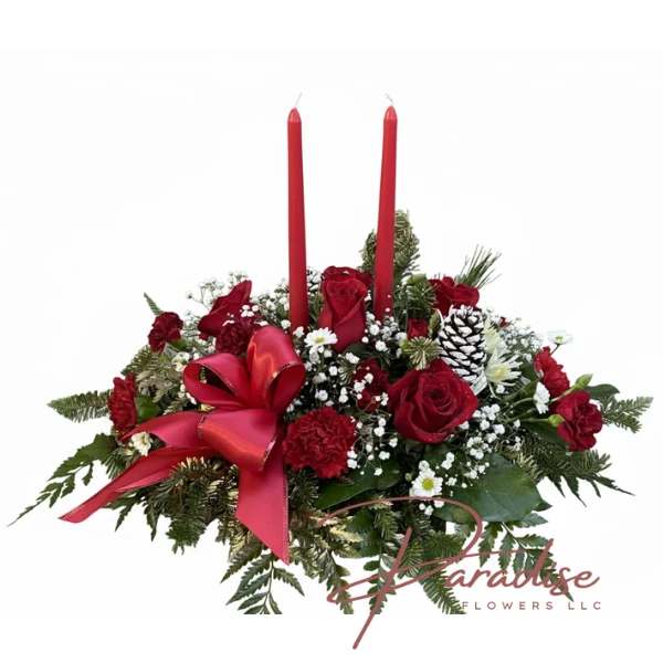 Christmas centerpiece with two red taper candles, red roses, white mums, frosted pinecones, and a red satin bow.
