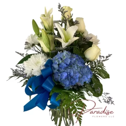 Dad's Day Floral Tribute featuring blue hydrangeas, white roses, lilies, and daisies accented with lush greenery, perfect for Father's Day.