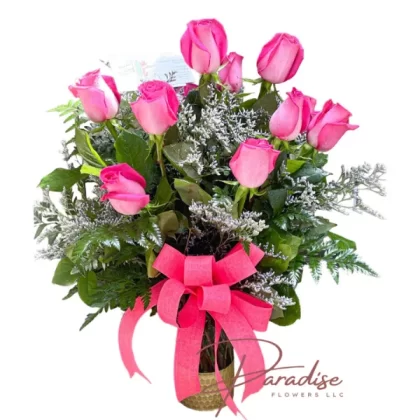 One dozen pink roses arranged in a golden vase, symbolizing sophistication, grace, and admiration.