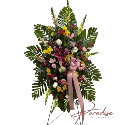 Eternal Life Standing Spray featuring pink spray roses, white, yellow, and pink snapdragons, white roses, yellow daisies, pink lilies, and mini carnations.