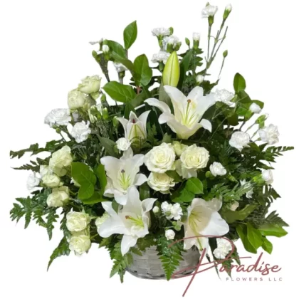 Eternal Rest floral arrangement featuring white lilies, roses, spray roses, mini carnations, and greenery.