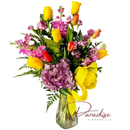 Fiesta Flowers bouquet featuring yellow roses, tulips, purple stocks, mini carnations, and hydrangea.