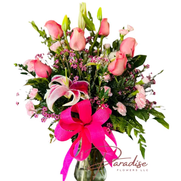 Forever Grateful Floral Display featuring pink roses, mini carnations, white lilies, stargazer lilies, and pink wax-flowers in a vase.