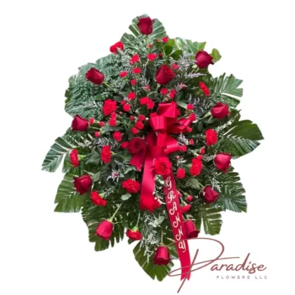 Graceful Tribute standing spray featuring red roses, carnations, mini carnations, and lush greenery.