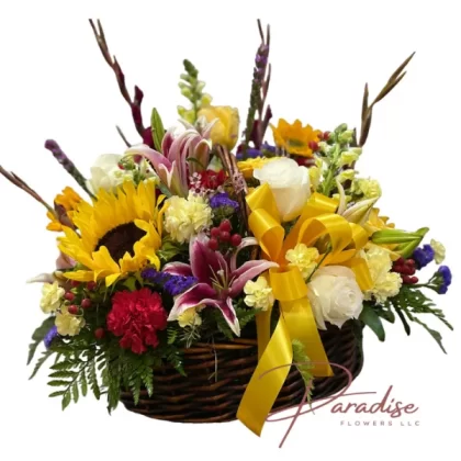 Joyful Harvest floral arrangement featuring pink roses, snapdragons, mini carnations, carnations, lilies, sunflowers, gladioli, liatris, limonium, and lush greenery.