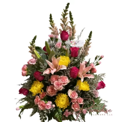 Majesty In a Basket featuring snapdragons, pink roses, spray roses, mini carnations, lilies, chrysanthemums, limonium, and lush greenery arranged elegantly.