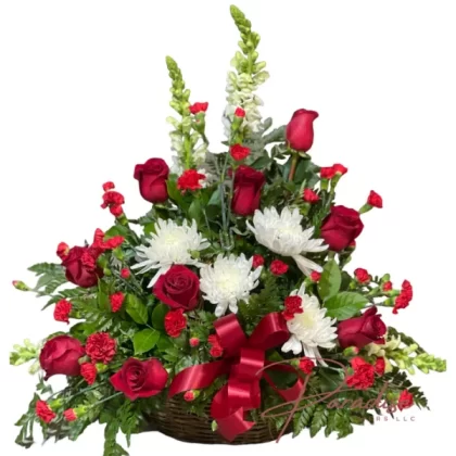 Reborn Spirit floral arrangement featuring white snapdragons, white spider mums, red mini carnations, red roses, and lush greenery.