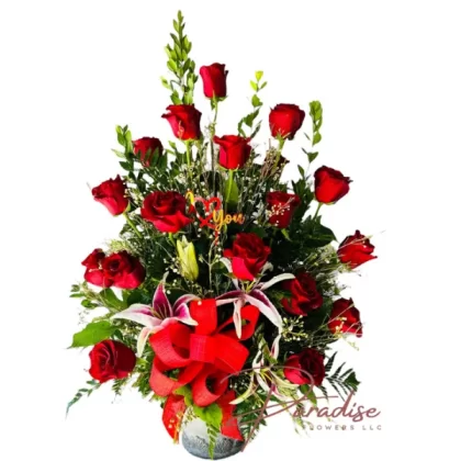 Romance in Bloom Arrangement featuring 18 red roses, pink lilies, and lush greenery in a chic vase.