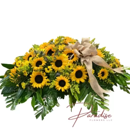 Sunflower Sentiments Casket Spray featuring sunflowers, yellow daisies, golden solidago blooms, and lush greenery.