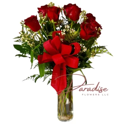 One dozen red roses delicately arranged in a glass vase, adorned with a red satin ribbon, symbolizing love and passion.