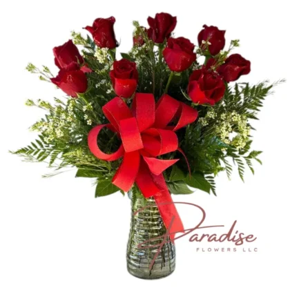 Long stem red rose bouquet with one dozen roses in a glass vase, adorned with a red satin ribbon, perfect for romantic gestures.