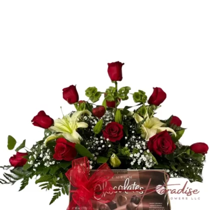 Unending Affection Bouquet featuring 18 red roses, white lilies, baby's breath, and lush greenery, accompanied by a box of chocolates.