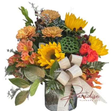 Welcome Fall floral arrangement featuring red roses, gold chrysanthemums, orange astromelias, spray roses, sunflowers, and lush greenery.