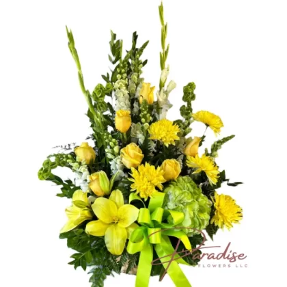 Yellow Serenity floral arrangement featuring white snapdragons, gladiolus, yellow roses, yellow lilies, yellow spider mums, and green hydrangeas.