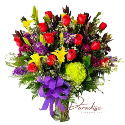 Timeless Romance Bouquet featuring red roses, purple stock, yellow lilies, green hydrangeas, and lush greenery.