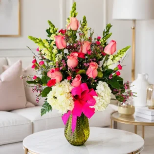 Cheers to Flowers arrangement serving as a living room centerpiece on a coffee table.