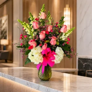 Cheers to Flowers premium arrangement displayed on a marble entryway table.