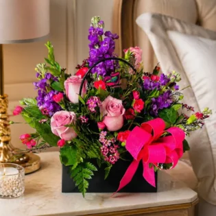 Enchanting Blossom Handbag placed on an elegant bedside table.