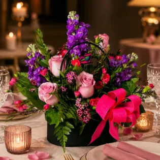 Enchanting Blossom Handbag arrangement serving as an elegant dining table centerpiece.