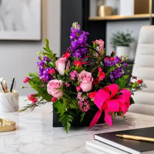 Enchanting Blossom Handbag beautifully styled on a modern office desk.